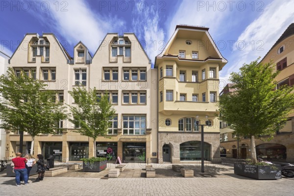 Cultural office, buildings, general architecture, pedestrian zone, benches, city trees, pedestrians