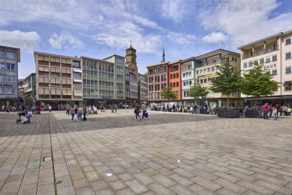 Square, church tower of the collegiate church Stuttgart, trees, pavement slabs, pedestrians as
