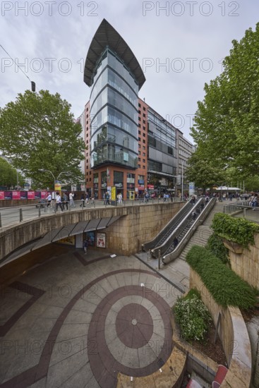 Pedestrian zone, modern architecture, concrete staircase, escalator, pedestrians as accessories,