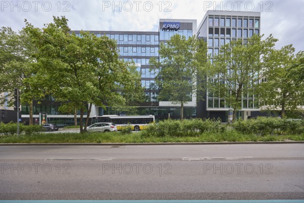 Auditing and management consultancy KPMG, modern architecture, street, public bus, trees, milky