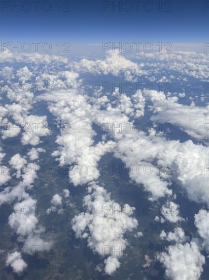 Aerial view from aeroplane at high altitude of white, bright cluster clouds Altocumulus,