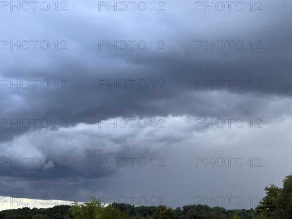 Gathering low pressure area with rain front dark stratus clouds Nimbostratus clouds over forest