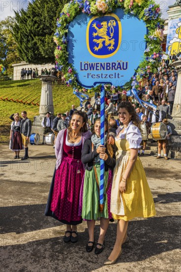 The landlady of the Löwenbräu festival tent in company with flower-decorated table, Wiesnwirte