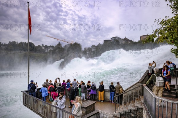 Visitors, tourists, taking selfies with smartphone, viewing platform Känzeli, Rhine Falls