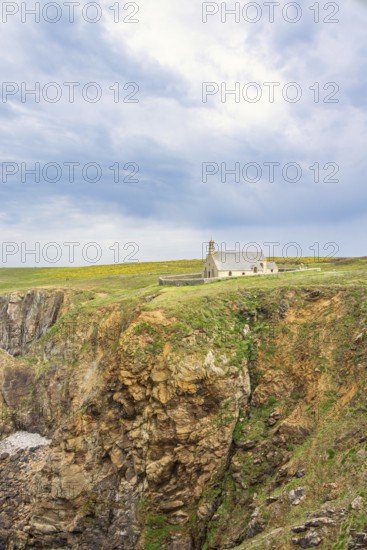 Chapelle Saint-They on the edge of a steep cliff a historical building on the dramatic french