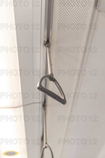 Close-up of the grab rails on the ceiling of a train, battery Electric train with green