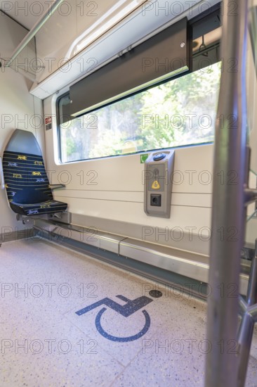 Train compartment with marked area for wheelchairs, battery Electric train with green electricity,