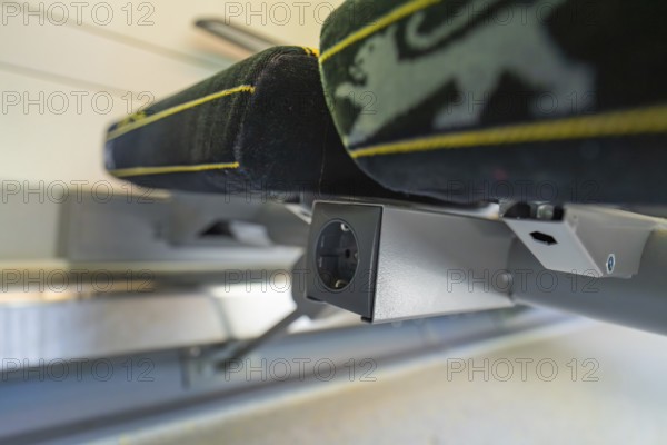 Detail of a modern seat with socket in the interior of a vehicle, battery Electric train with green