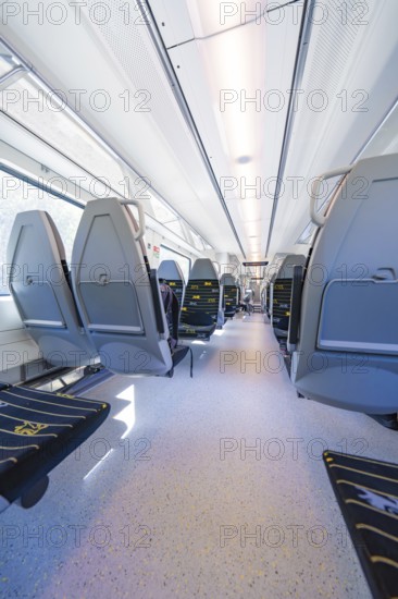 Spacious and bright train interior with modern seating arrangements, battery Electric train with