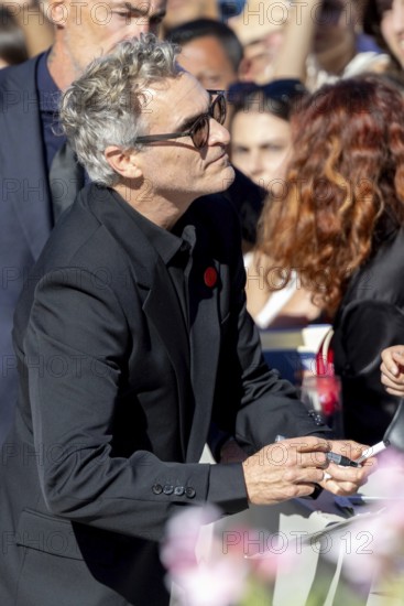 Venice, Italy - 3 September 2025: Joaquin Phoenix signing autographs during the Red Carpet of - The