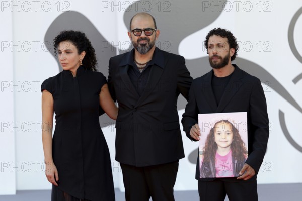Venice, Italy - 3 September 2025: Clara Khoury, Amer Hlehel, Motaz Malhees with a portrait of