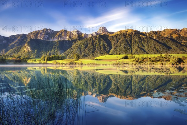 Stockhorn mountain reflected in the Uebeschi lake in the morning light, Gürbetal, Canton Bern,