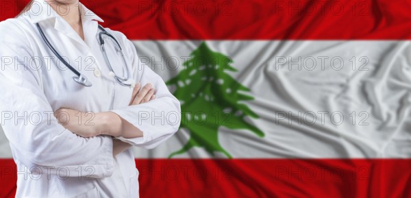 Doctor with crossed arms on Lebanon flag. Lebanese health and care concept. Female doctor on
