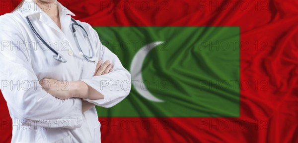 Doctor with crossed arms on Maldives flag. Maldivian health and care concept. Female doctor on