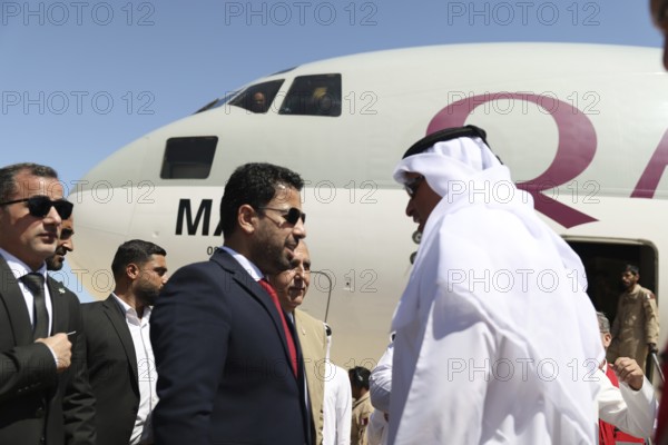 Syrian Health Minister Musab al-Omar welcomes a Qatari aircraft loaded with medical and