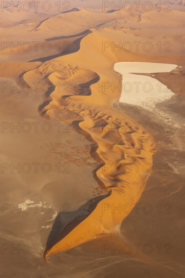 Sand dunes and dry pans in the Namib Desert. In the evening. Aerial view. Namib-Naukluft Park,
