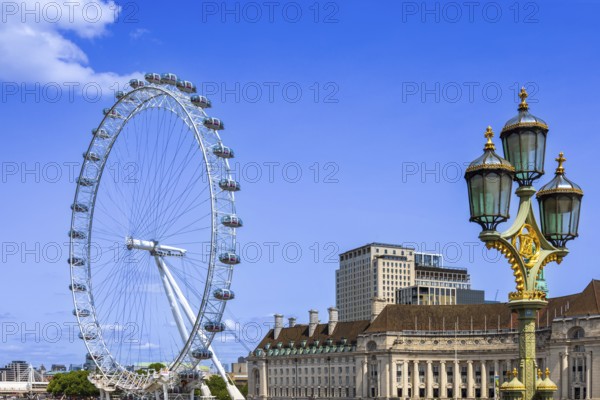 Travel attraction of London Eye Millenium ferris wheel overlooking London Big Ben and British