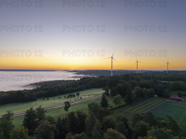 Expansive landscape with wind turbines and a veil of mist at dawn, near Schorndorf, Rems-Murr