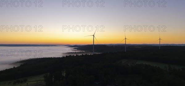 Several wind turbines above a foggy landscape at sunrise, near Schorndorf, Rems-Murr district,
