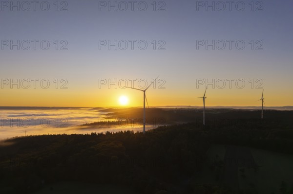 Three wind turbines towering in the morning landscape with fog, near Schorndorf, Rems-Murr-Kreis,