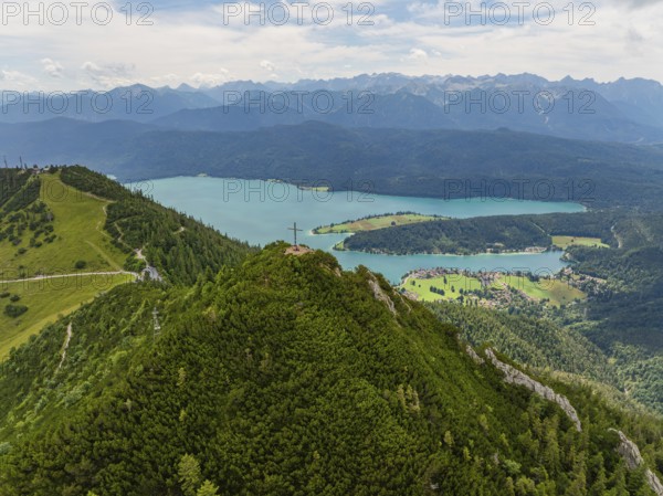 Panorama of a mountain and lake landscape with a summit cross in the foreground, Herzogstand