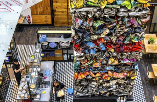 Interior design, artwork made from compressed scrap cars, partially vacant Shopping Quartier 205 in