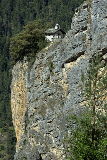 The small Chapelles des Pontis chapel on a rocky outcrop on the precipice, Chandolin, Val