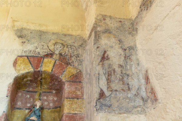Saint Jean Chapel features ancient wall paintings showcasing religious figures with vibrant colors