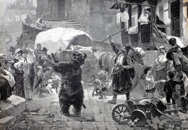 Bear handler with a dancing bear, trained bear, circus has come to town and is giving a