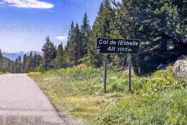 Sign at the top of the Col de l'Echelle Echelle Alpine pass with altitude indication 1762 m metres,