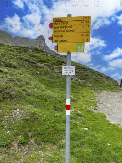 Information board Sign with arrow-shaped signpost at the top of the Splügenpass Passo dello Spluga