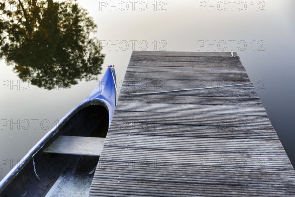 Jetty, wooden jetty with boat at a pond, camping site, evening light, Hodorf, Itzehoe,