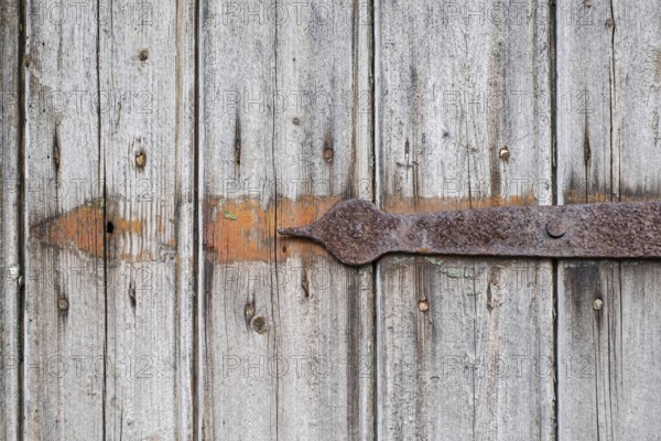 Detail of an old wooden door with rusty metal fittings, texture, background, Münsterland, North