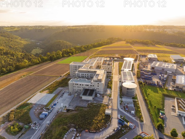 Building complex integrated into a rural environment with fields and trees, new hospital building,