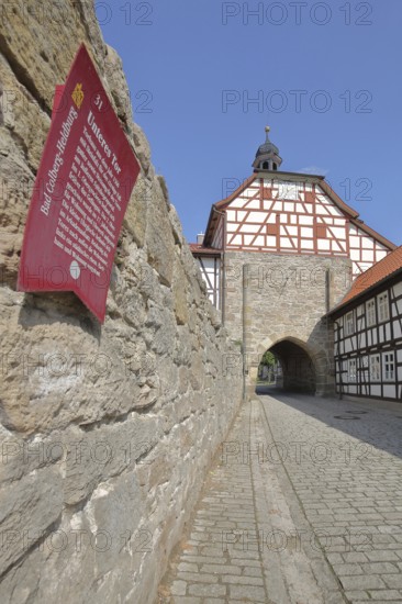 Historic lower gate with spire and clock and town wall, Tor tor, town gate, information board with