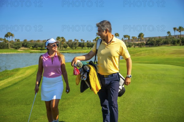 Couple of golfers walking and chatting on a picturesque golf course under a bright sun, enjoying a