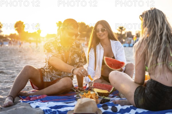 Friends sharing laughter and enjoying juicy watermelon and sweet pineapple during a picturesque