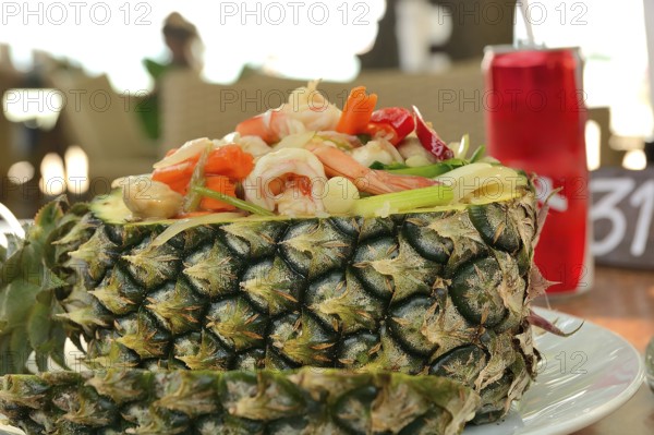 Pineapple fried rice with shrimp and vegetables served in a pineapple, a popular thai dish,
