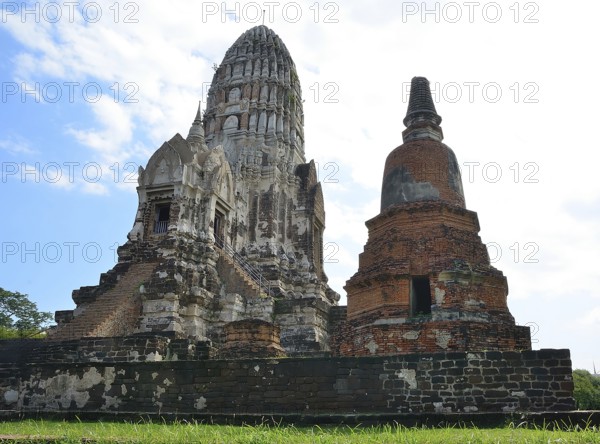 Crumbling ancient buddhist temple wat ratchaburana with ornate prang and damaged stupa, displaying