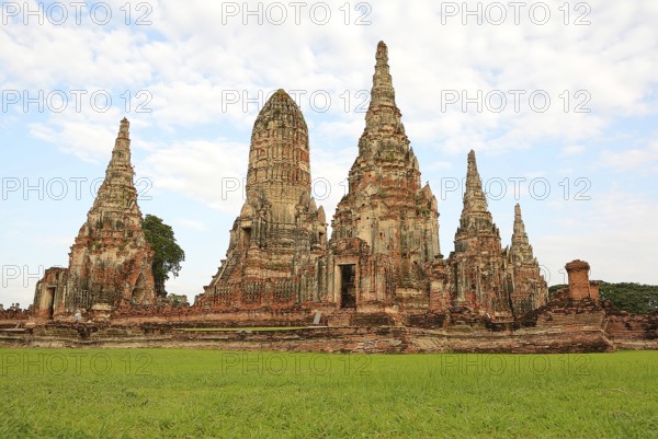 Scenic view of the historical wat chaiwatthanaram temple with its towering prangs and serene green