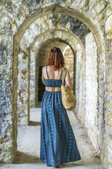 Tourist admiring the arches of sauveterre de bearn in france, enjoying a summer vacation exploring