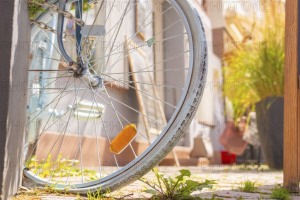 Close-up of a labelled bicycle tyre with green city pavement, small town of Perle Calw, district of