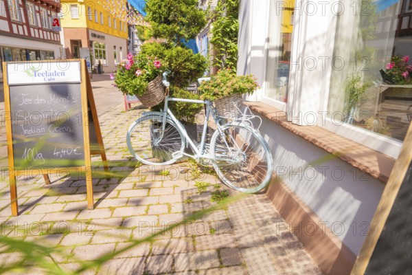 Scenes of a charming street with a pale bicycle and flowers, small town of Perle Calw, district of