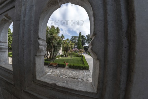 Lush gardens, framed by ornate stone arches, offer a tranquil escape in the heart of istanbul,