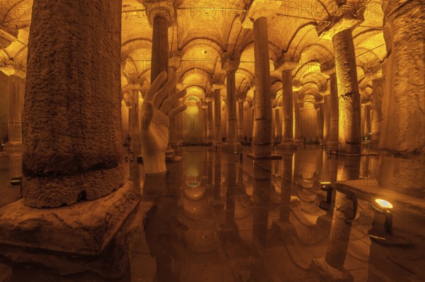 Giant hand sculpture rising from the water surface of the ancient basilica cistern in istanbul,