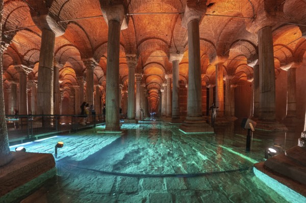 Tourists walking on a walkway in the basilica cistern, a historical landmark in istanbul, turkey,