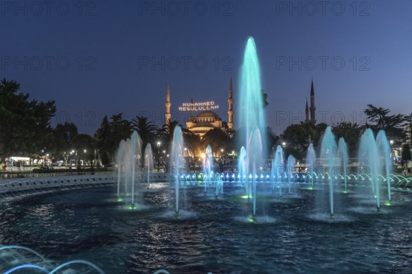 Colorful illuminated fountains enhance the beauty of hagia sophia at twilight in istanbul, creating