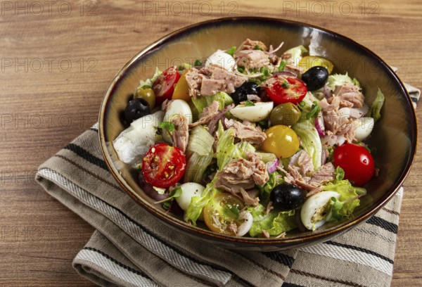 Salad with canned tuna, vegetable salad with quail eggs, lettuce, red onion, cherry tomatoes,