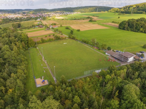 Sports field and buildings surrounded by trees and fields near a village, VFL Stammheim, Calw,