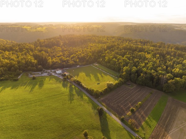 Fields and forest in the light of the sunset with long shadows, VFL Stammheim, Calw, Black Forest,